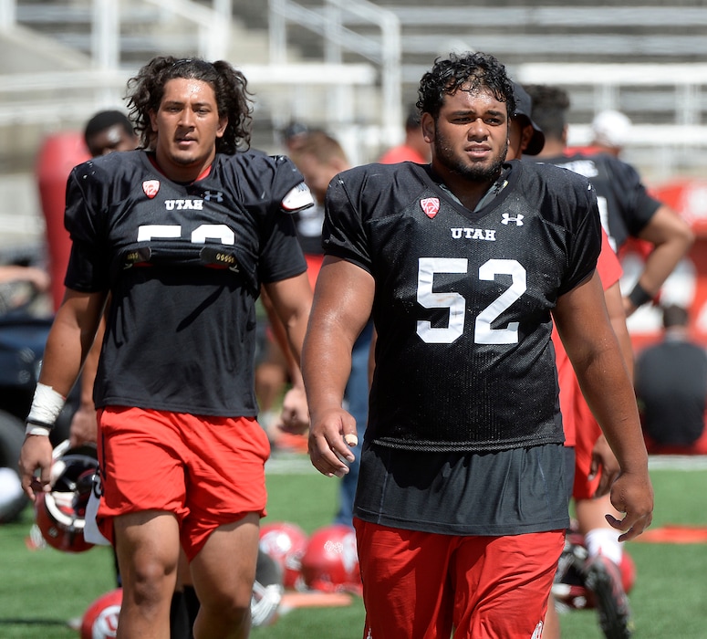 (Al Hartmann  |  The Salt Lake Tribune)  Ute defensive end Bradlee Anae, left, and defensive tackle John Penisini call it a day after practicing Tueday Aug. 15. 
