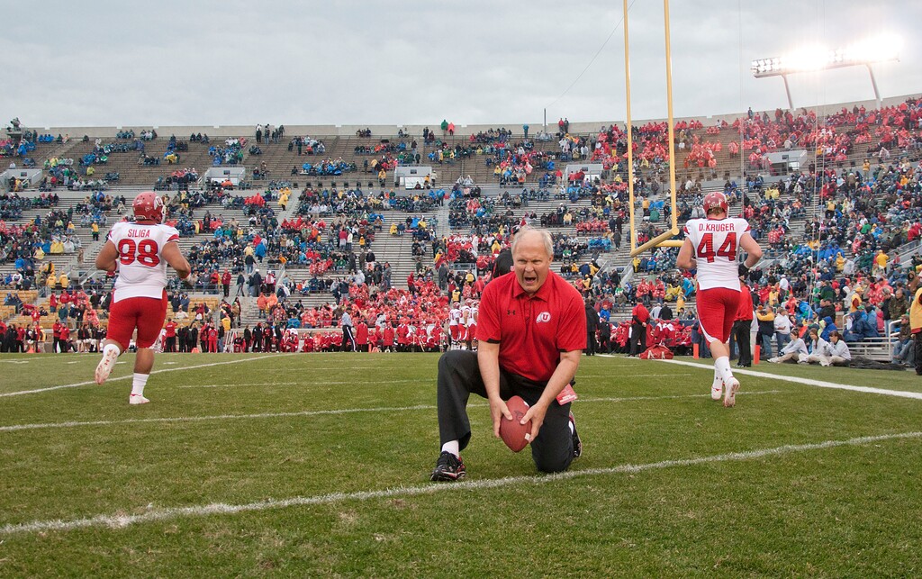 (Michael Mangum | Special to The Tribune) John Pease, pictured here running drills with Utah players during pre-game warmups at Notre Dame Stadium in 2010, died this week at the age of 77. The late Utes assistant had a tremendous influence on Utah defensive coordinator Morgan Scalley.