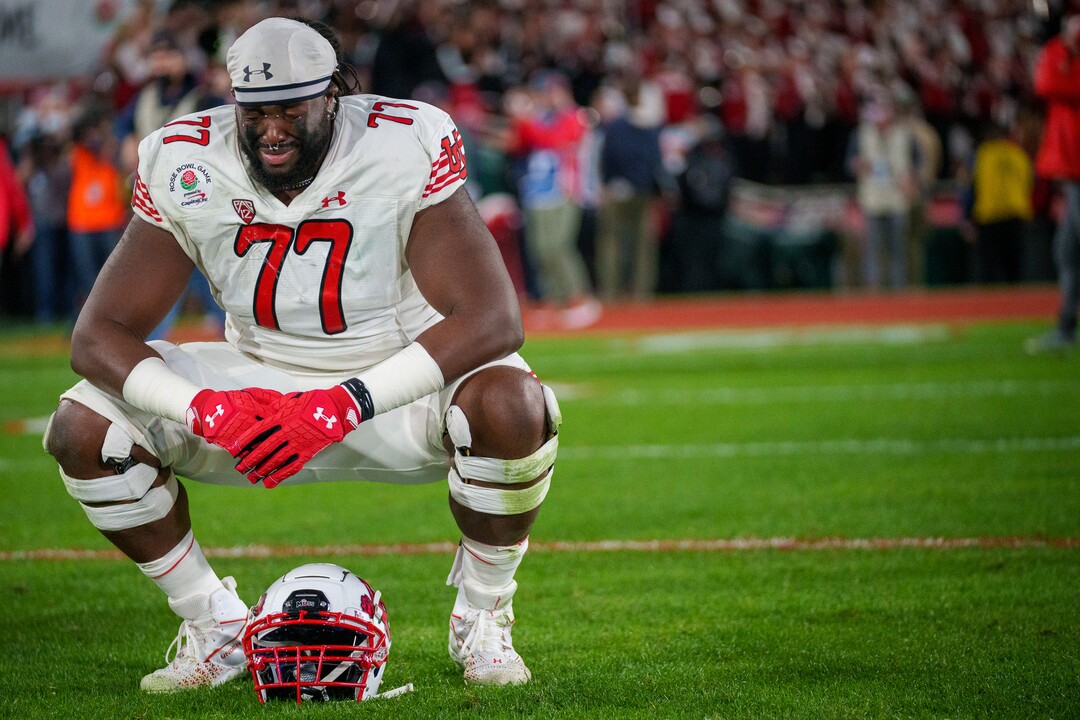 (Trent Nelson  |  The Salt Lake Tribune) Utah Utes offensive lineman Bamidele Olaseni (77) takes a moment on the field after the loss, as the Utah Utes face the Ohio State Buckeyes at the Rose Bowl in Pasadena, Calif., on Saturday, Jan. 1, 2022.