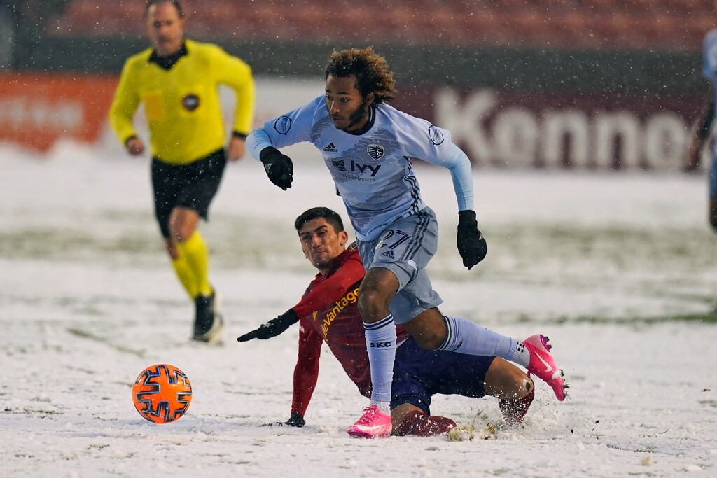 Sporting Kansas City forward Gianluca Busio (27) battles against Real Salt Lake midfielder Pablo Ruiz, rear, in the first half during an MLS soccer match Sunday, Nov. 8, 2020, in Sandy, Utah. (AP Photo/Rick Bowmer)