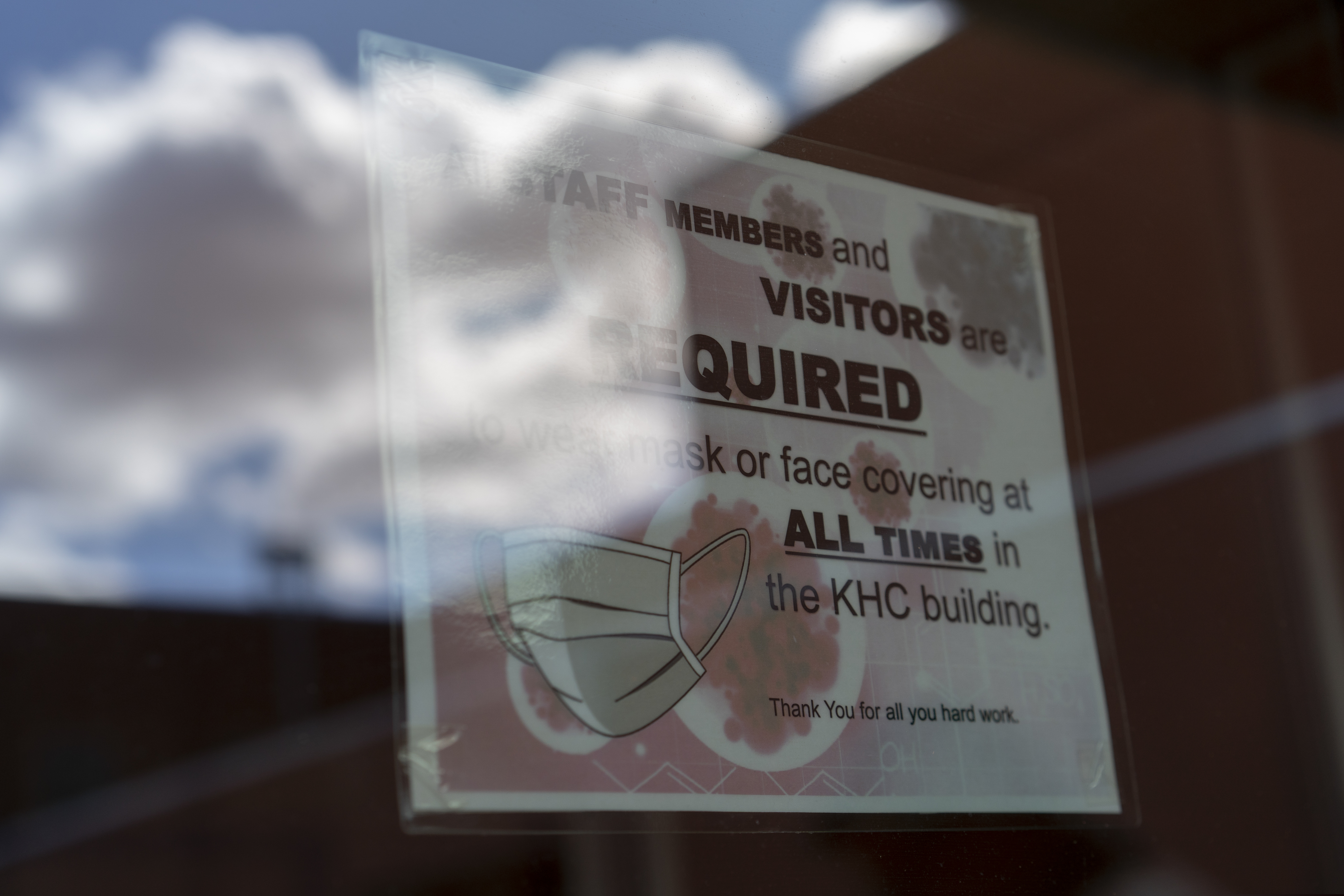 A sign on a door warns people to wear face coverings at the Kayenta Health Center on the Navajo reservation in Kayenta, Ariz., on April 18, 2020. The reservation has some of the highest rates of coronavirus in the country. Team Rubicon is helping with medical operations as cases of COVID-19 surge. (AP Photo/Carolyn Kaster)