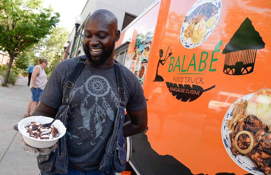 (Francisco Kjolseth  |  The Salt Lake Tribune)  Ibou Fall whips up a Senegalese French toast from the Balabe Senegalese food truck during Trolley Square Food Truck Night on Wednesday, July 17, 2019. Three of the vendors that showed up, along with four others, will vie for the title of Best New Food Truck on Aug. 3 at the Food Truck and Brewery Battle at The Gateway.