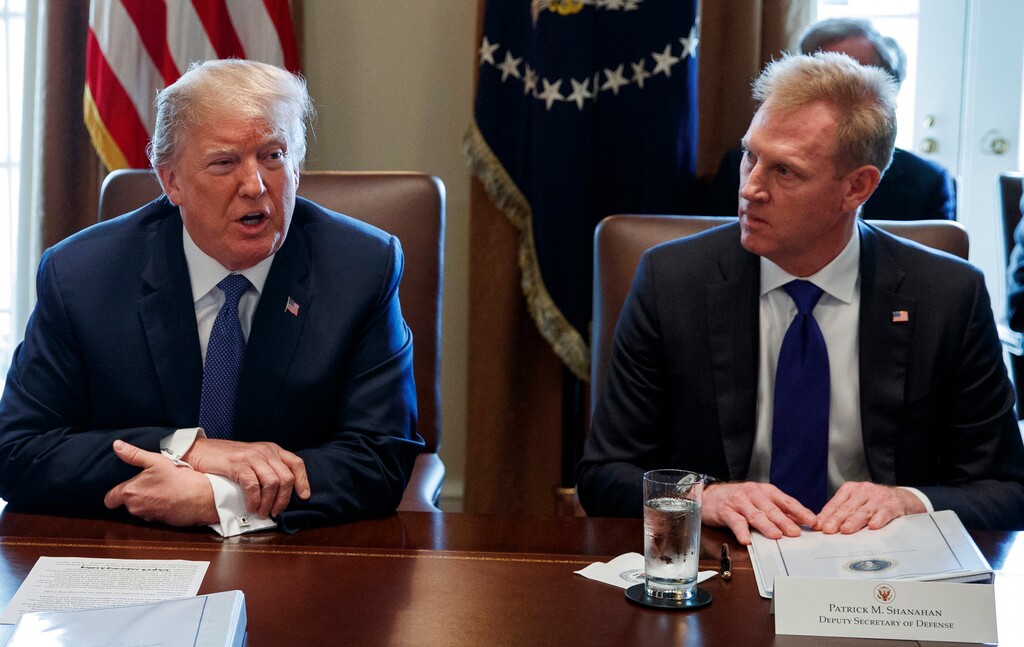 FILE - In this April 9, 2018, file photo, Deputy Secretary of Defense Patrick Shanahan, right, listen as President Donald Trump speaks during a cabinet meeting at the White House, in Washington. A U.S. administration official says that Defense Secretary Jim Mattis will leave his post Jan. 1, 2019, as Trump is expected to name Shanahan as acting secretary. (AP Photo/Evan Vucci, File)