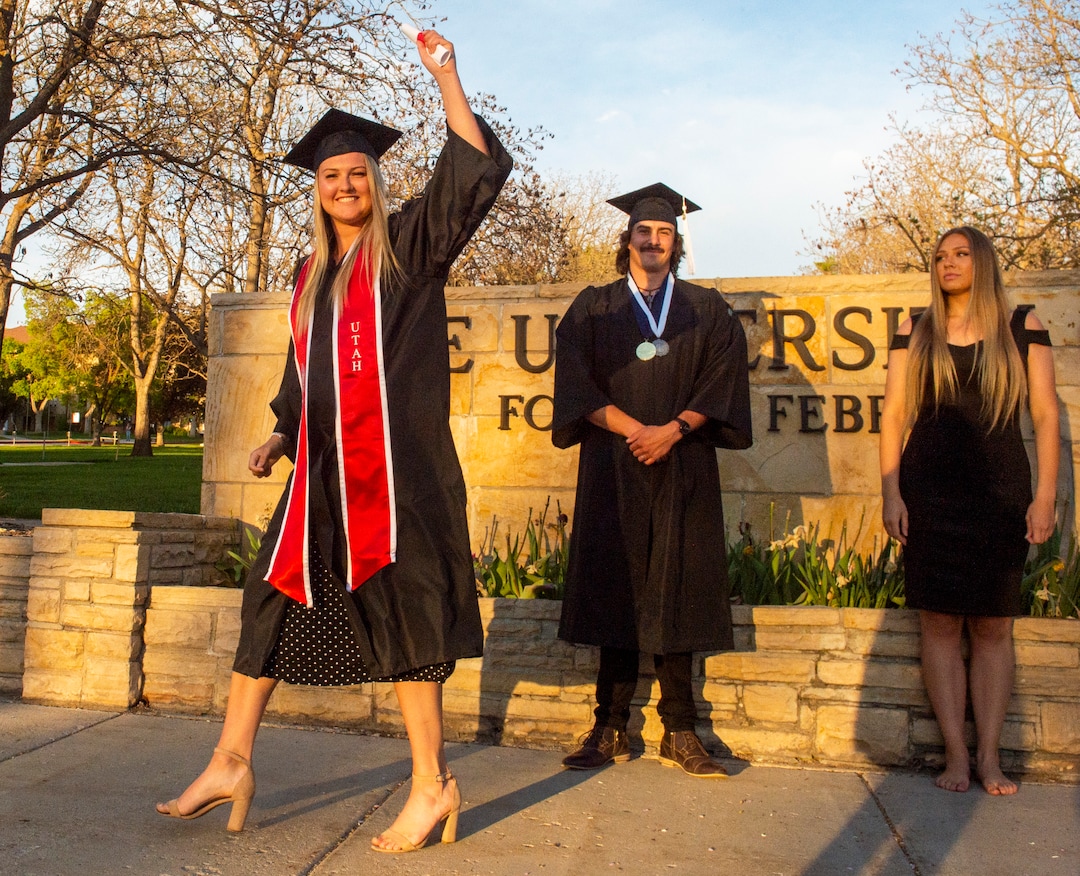 (Rick Egan  |  The Salt Lake Tribune)    Emma McFee celebrates her graduation after recieveing her diploma from her friend Chafen Robbins and Hanna Bertelsen in a mock ceremony at presidents circle at the University of Utah, Thursday April 30, 2020