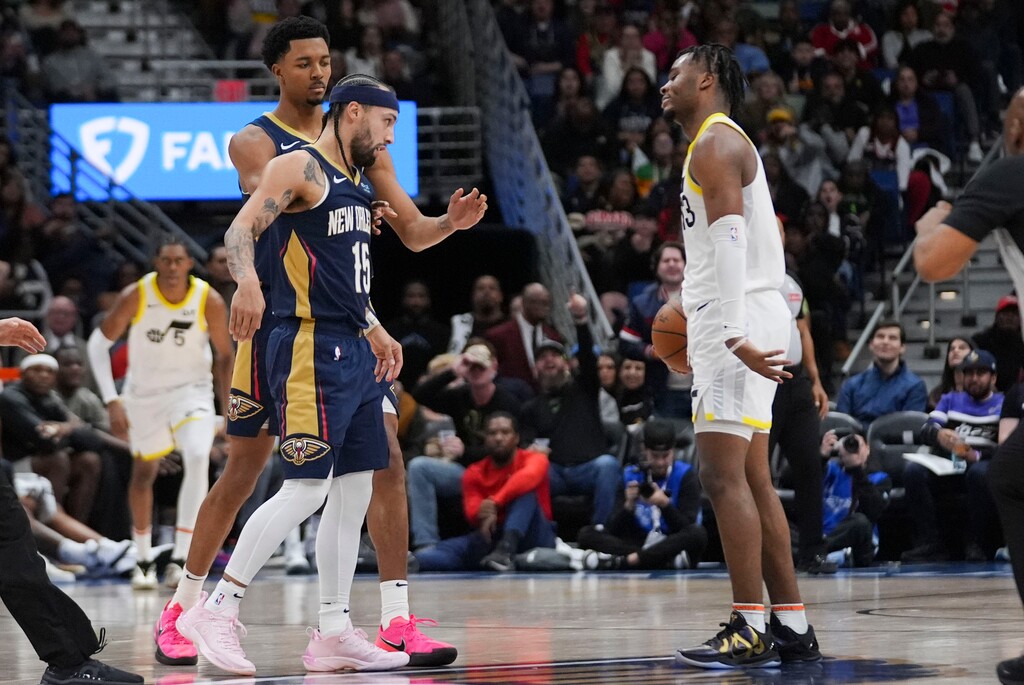 New Orleans Pelicans guard Jose Alvarado (15) gets into a scuffle with Utah Jazz guard Isaiah Collier in the second half of an NBA basketball game in New Orleans, Friday, Jan. 17, 2025. (AP Photo/Gerald Herbert)