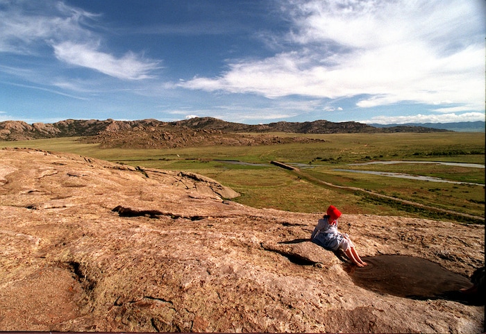 Rick Egan  | Tribune File Photo 

Jessica Hess, 14, Star Valley Wyoming, soaks her feet in a puddle of water on top of Independence Rock, after pulling a handcart all day.  