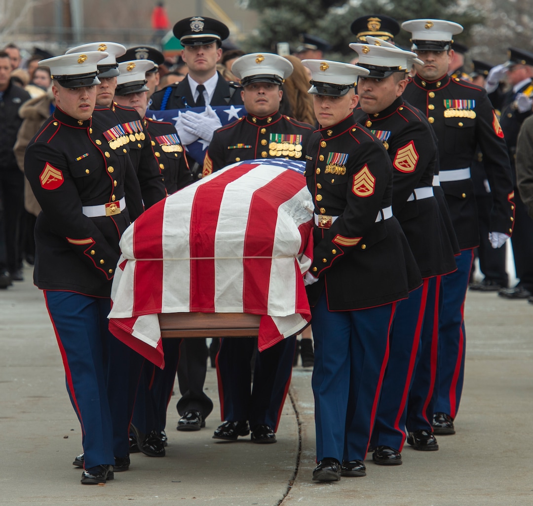 (Rick Egan  |  The Salt Lake Tribune)     Pall Police officers salute, as the pall bearers bring the casket out of the Maverik Center, after David Romrell 's funeral in West Valley City, Wednesday, Dec. 5, 2018.