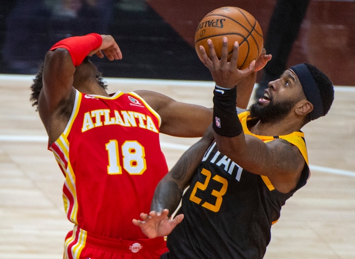 (Rick Egan | The Salt Lake Tribune) Utah Jazz forward Royce O'Neale (23) goes in for a shot, as Atlanta Hawks forward Solomon Hill (18) defends, in NBA action between the Utah Jazz and the Atlanta Hawks at Vivint Arena, on Friday, Jan. 15, 2021.