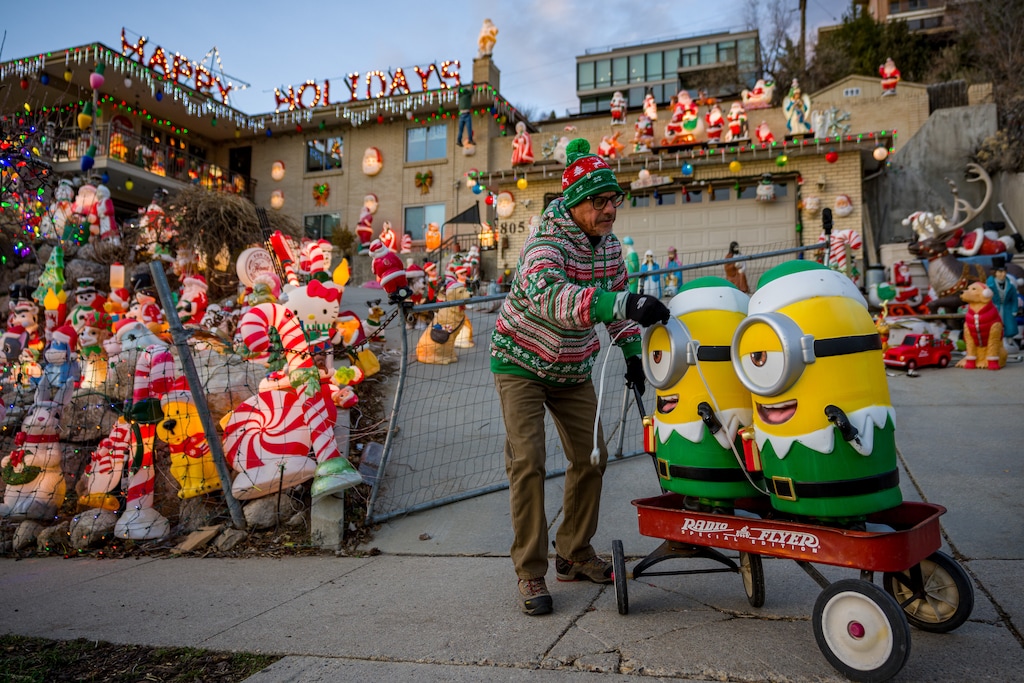 (Trent Nelson  |  The Salt Lake Tribune) Forrest Nunley setting up his display, Frosty's Winter Wonderland, in Salt Lake City on Monday, Dec. 22, 2025. Nunley and his family are selling his vast collection of decor at a yard sale on Saturday. Frosty's Winter Wonderland is officially retiring. 
