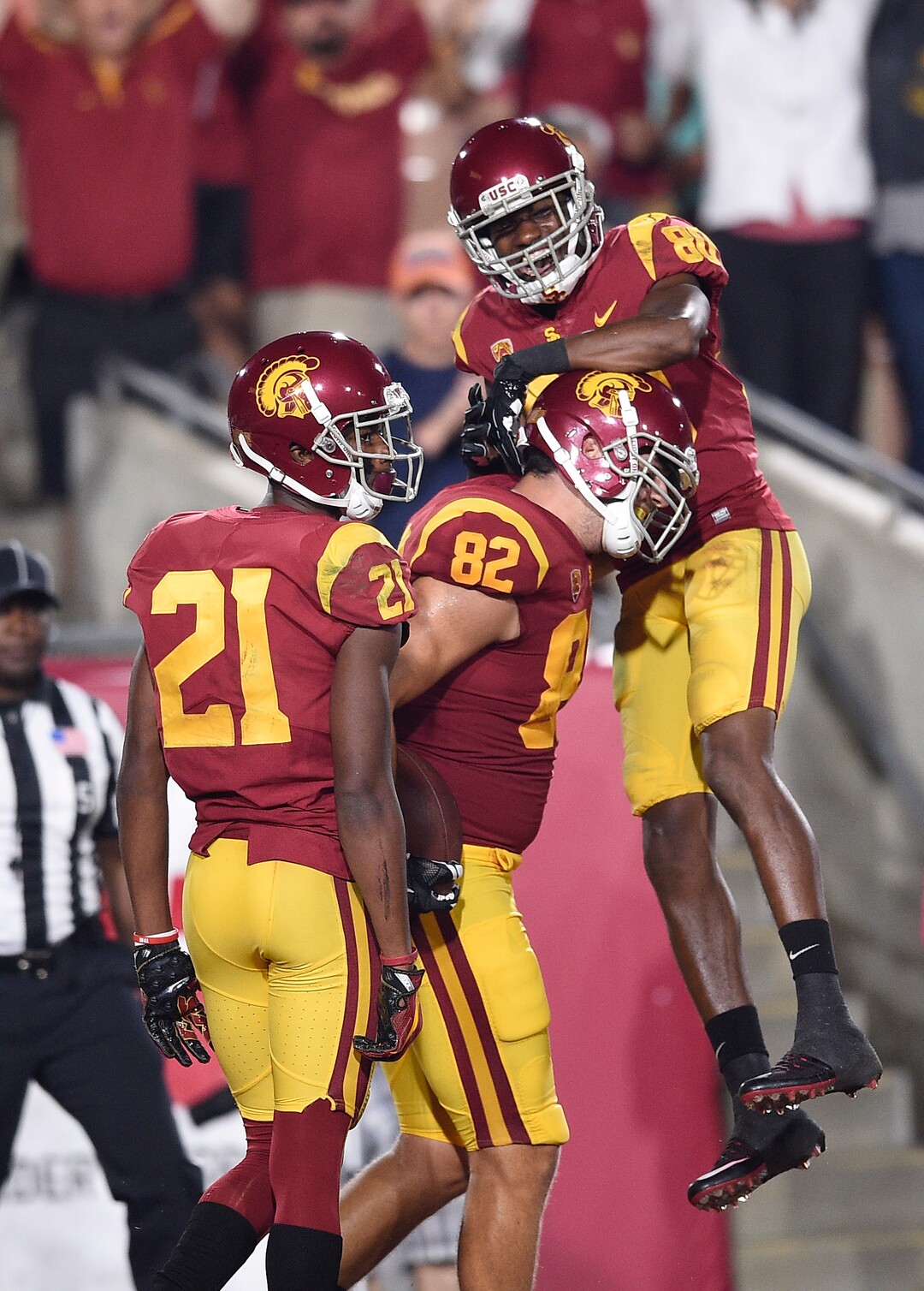 Southern California wide receiver Deontay Burnett, top, celebrates a touchdown reception by tight end Tyler Petite (82) while wide receiver Tyler Vaughns (21) stands nearby during the second half of an NCAA college football game against Utah in Los Angeles, Saturday, Oct. 14, 2017. USC won 28-27. (AP Photo/Kelvin Kuo)
