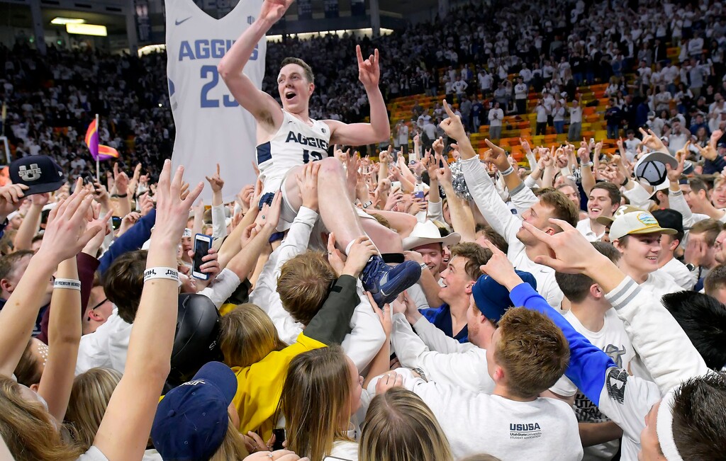 (Eli Lucero | The Herald Journal) Fans celebrate with Utah State forward Justin Bean on the court after Utah State defeated Nevada 81-76 in an NCAA college basketball game Saturday, March 2, 2019, in Logan, Utah.