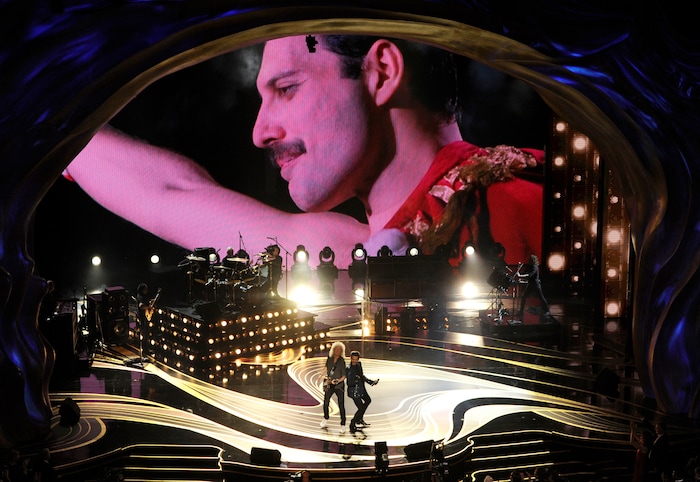 An image of Freddie Mercury appears on screen as Brian May, left, and Adam Lambert of Queen perform at the Oscars on Sunday, Feb. 24, 2019, at the Dolby Theatre in Los Angeles. (Photo by Chris Pizzello/Invision/AP)