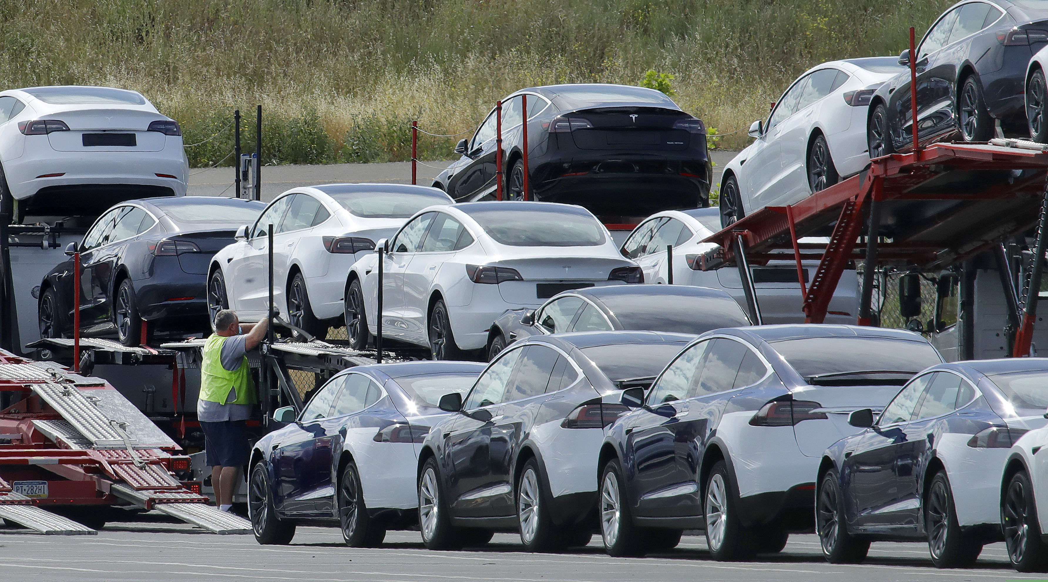 FILE - In this May 13, 2020, file photo, Tesla cars are loaded onto carriers at the Tesla electric car plant in Fremont, Calif. (AP Photo/Ben Margot, File)