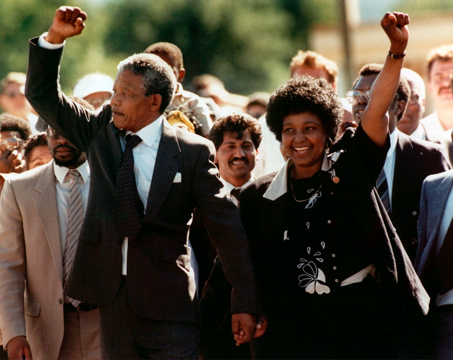 (The Associated Press) In this file photo dated Sunday, Feb. 11, 1990, Nelson Mandela and his wife, Winnie, walk hand in hand, raising their clenched fists upon his release from Victor prison, Cape Town, after 27 years in detention. South African state broadcaster SABC said Monday April 2, 2018, that anti-apartheid activist Winnie Madikizela-Mandela has died.