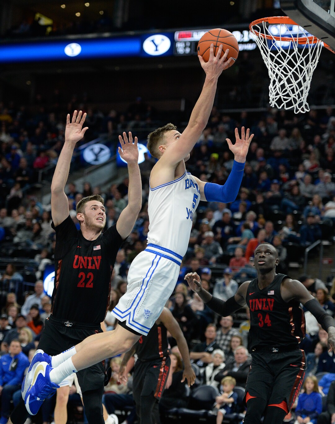 (Francisco Kjolseth  |  The Salt Lake Tribune)  Brigham Young Cougars guard Jake Toolson (5) sails past UNLV Rebels forward Vitaliy Shibel (22) as BYU takes on UNLV in men's NCAA basketball at Vivint Smart Home Arena in Salt Lake City on Sat. Dec. 7, 2019.