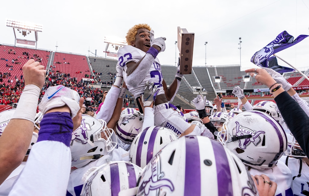 (Leah Hogsten | The Salt Lake Tribune) Lehi's River Moore celebrates the win with the team.  Lehi High School defeated Springville High School 35-6 to win the 5A State Fooball Championship title, Nov. 19, 2021 at Rice-Eccles Stadium. 