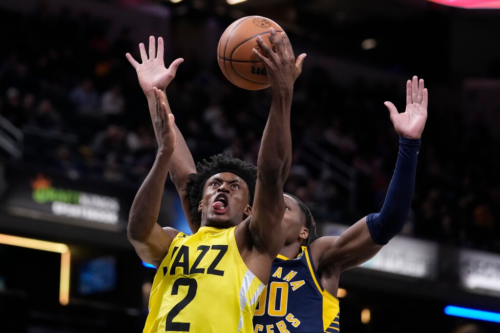 Utah Jazz guard Collin Sexton (2) shoots in front of Indiana Pacers guard Bennedict Mathurin (00) during the second half of an NBA basketball game in Indianapolis, Monday, Feb. 13, 2023. The Jazz defeated the Pacers 123-117. (AP Photo/Michael Conroy)