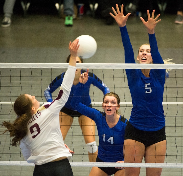 (Rick Egan  |  The Salt Lake Tribune)    Lone Pea Knights  Madelyn Robinson (9) hits the ball, as Pleasant Grove Vikings  Baylie Bishop (14) and Heather Gneiting (5) defend, in 6A volleyball championship action, Pleasant Grove vs. Lone Peak, at Utah Valley University, Saturday, November 4, 2017.