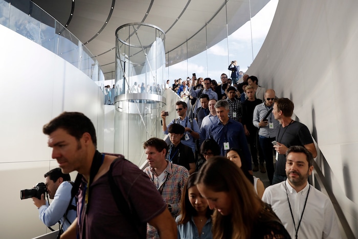 People arrive for a new product announcement at the Steve Jobs Theater on the new Apple campus, Tuesday, Sept. 12, 2017, in Cupertino, Calif. (AP Photo/Marcio Jose Sanchez)