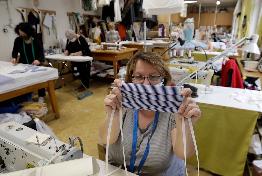 (Petr David Josek  |  Associated Press) An employee of the costume workshop of Prague's National Theater displays a face mask. Fabric shops in Utah are selling materials to make homemade masks in the wake of the coronavirus pandemic, but Utah health care providers are asking people not to donate them to hospitals or clinics.