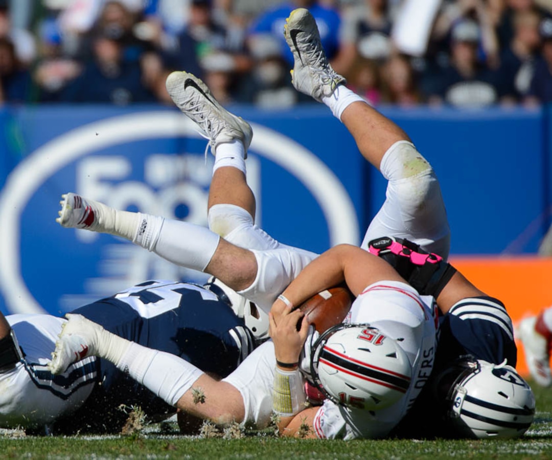 (Trent Nelson | The Salt Lake Tribune)  Brigham Young Cougars defensive lineman Corbin Kaufusi (90) sacks Northern Illinois Huskies wide receiver Cole Tucker (18) as BYU hosts Northern Illinois, NCAA football in Provo, Saturday Oct. 27, 2018.