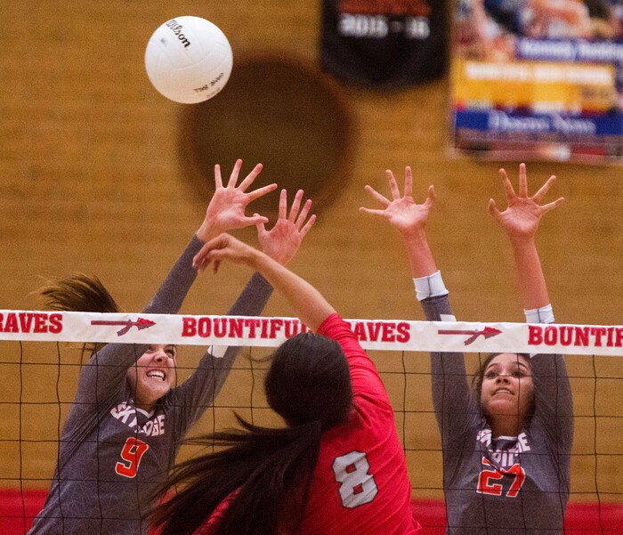 (Rick Egan  |  The Salt Lake Tribune)  Kaybrie Pe'a (8) hits the ball for Bountiful, as Emilee Rupp (9) and Naomi Puludefend (27) defend for Skyridge, in volleyball action, Bountiful vs. Skyridge, at Bountiful High, Wednesday, September 6, 2017.