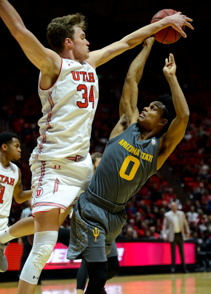 (Steve Griffin  |  The Salt Lake Tribune) Utah Utes forward Jayce Johnson (34) blocks the shot of Arizona State Sun Devils guard Tra Holder (0) during the Utah Utes versus Arizona State Sun Devils at the Huntsman Center on the University of Utah campus in Salt Lake City Sunday January 7, 2018.