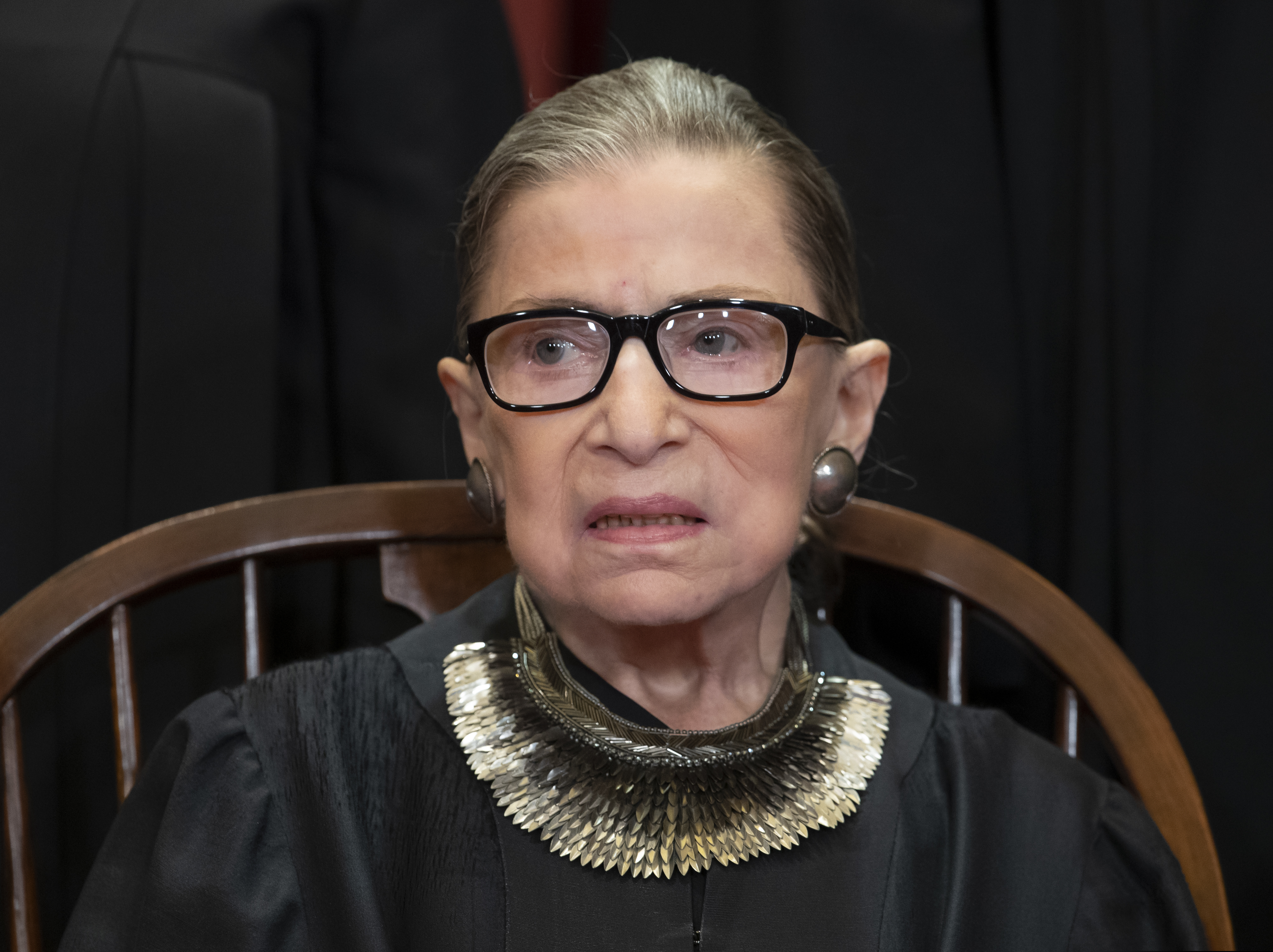 (AP Photo/J. Scott Applewhite) In this Nov. 30, 2018 file photo, Associate Justice Ruth Bader Ginsburg, nominated by President Bill Clinton, sits with fellow Supreme Court justices for a group portrait at the Supreme Court Building in Washington, Friday. The Supreme Court says Justice Ruth Bader Ginsburg has undergone surgery to remove two malignant growths from her left lung. It is Ginsburg’s third bout with cancer since joining the court in 1993.