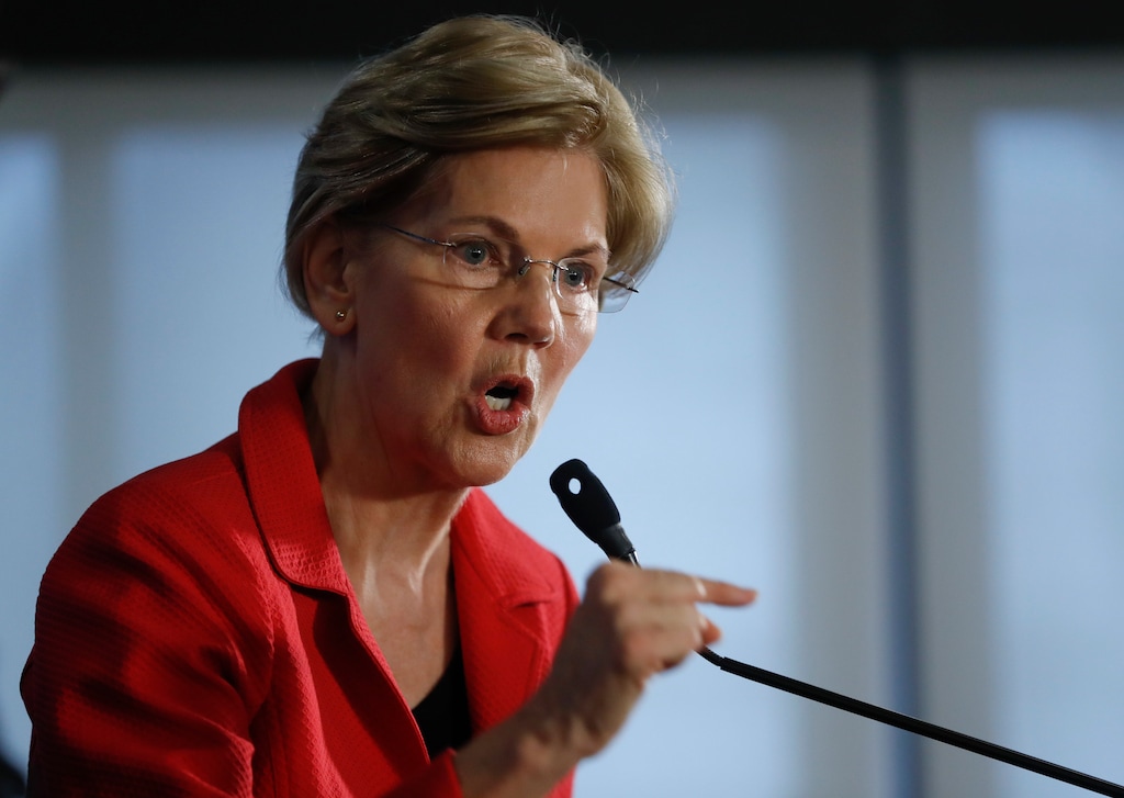 Sen. Elizabeth Warren, D-Mass., gestures while speaking at the National Press Club in Washington, Tuesday, Aug. 21, 2018. Warren wants a lifetime ban on members of Congress from getting hired as lobbyists after they leave public office. She also wants to prohibit lawmakers from owning or trading individual stocks while in office. (AP Photo/Pablo Martinez Monsivais)