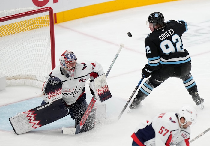 (Francisco Kjolseth | The Salt Lake Tribune) Washington Capitals goaltender Charlie Lindgren (79) blocks a shot from Utah Hockey Club center Logan Cooley (92) during a NHL hockey game at the Delta Center in Salt Lake City on Monday, Nov. 18, 2024.