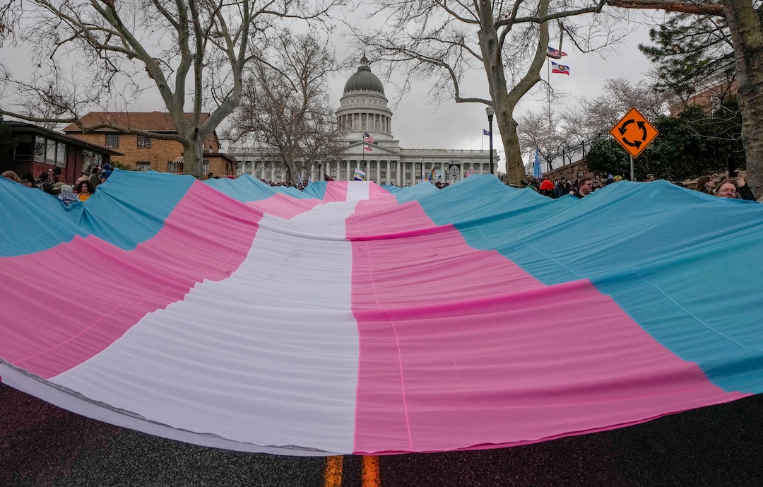 (Francisco Kjolseth  | The Salt Lake Tribune) Hundreds of people show up at the Utah State Capitol on Mar. 29, 2025 to fly the largest transgender pride flag in Utah. The unveiling of the flag is part of celebrations for Transgender Day of Visibility, hosted by local nonprofits Utah Pride Center and The Glitter Foundation.