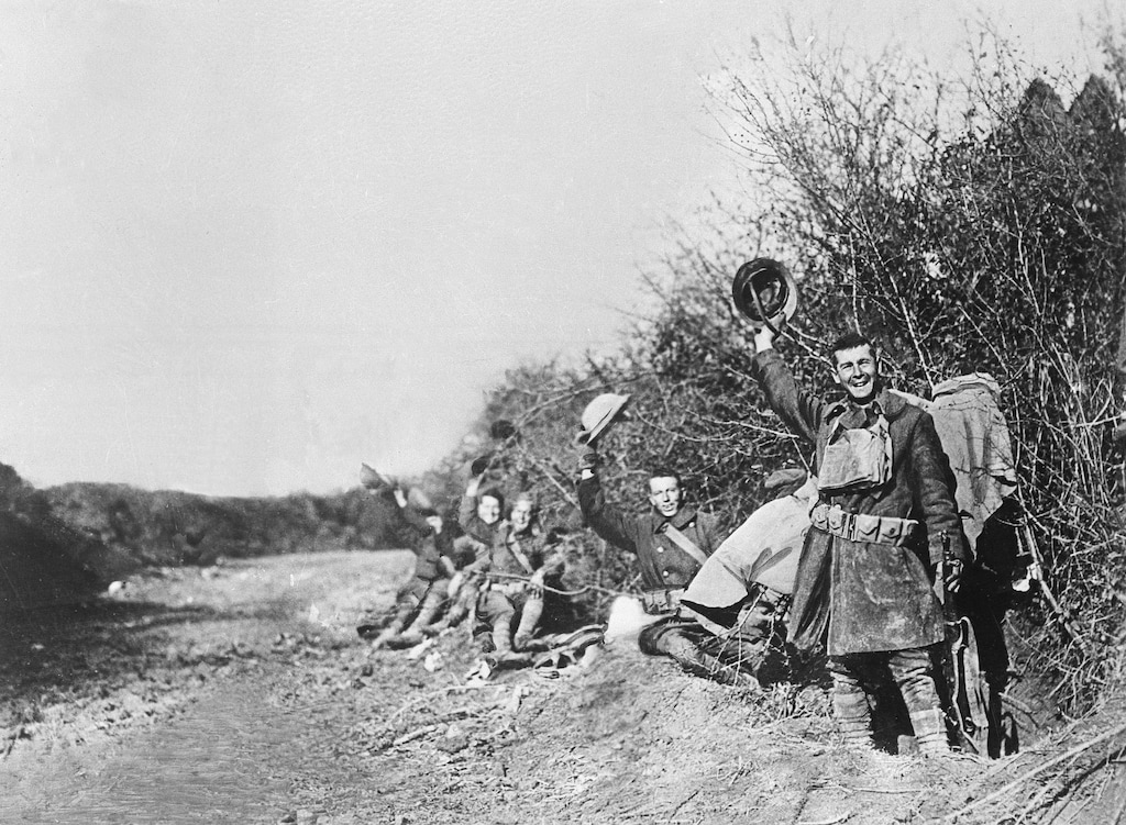 FILE - In this undated file photo American World War I soldiers wave their helmets after the Nov. 11, 1918 Armistice was signed in France. Hundreds of troops died on the final morning of World War I _ even after an armistice was reached and before it came into force. Death at literally the 11th hour highlighted the futility of a conflict that had become even more incomprehensible in four years of battle. (AP Photo, File)