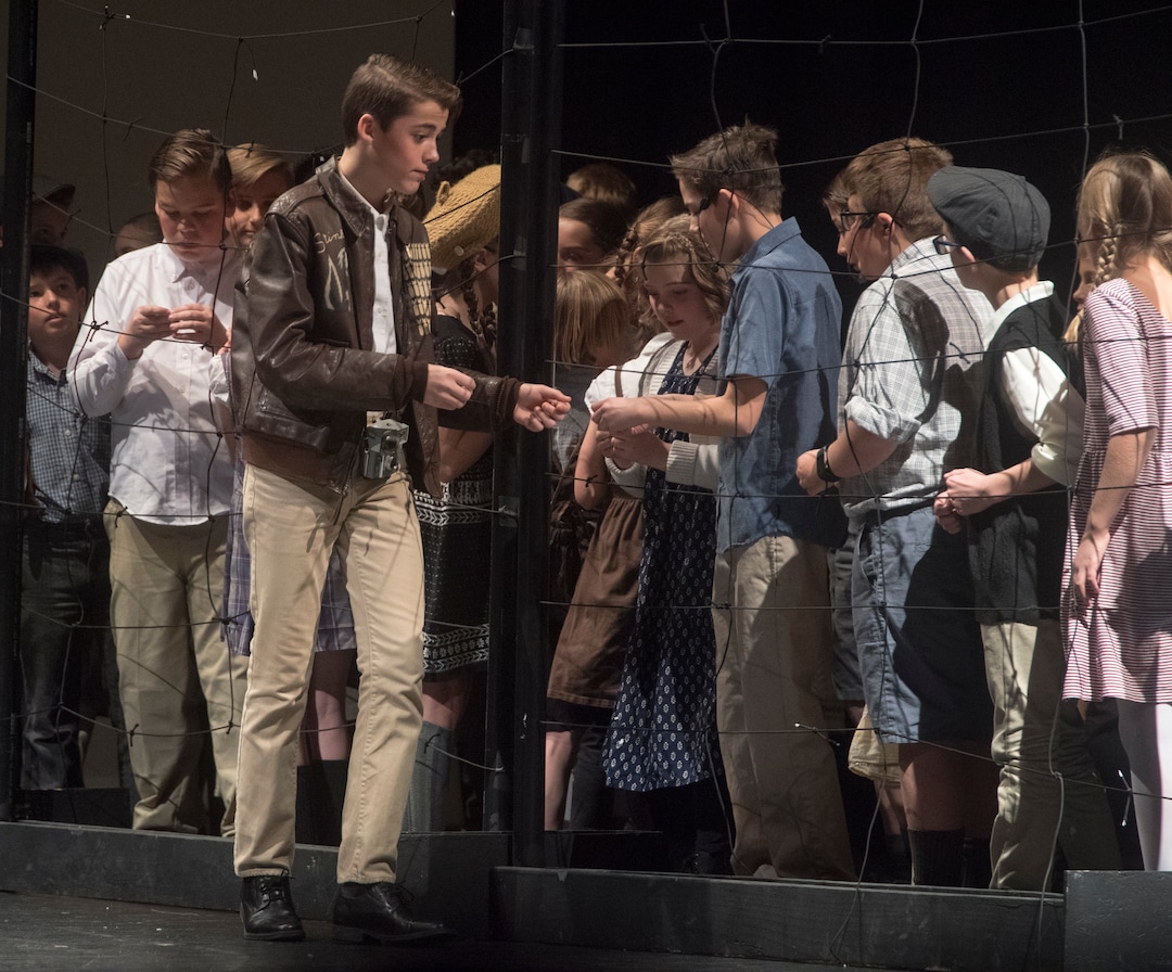 (Rick Egan  |  The Salt Lake Tribune)  Gabe Duggar playing the Candy Bomber, Gail Halvorsen, gives two sticks of gun to children in West Berlin Germany, in the Mueller Park Jr High production of "The Berlin Candy Bomber" at Woods Cross High School, Saturday, November 11, 2017.