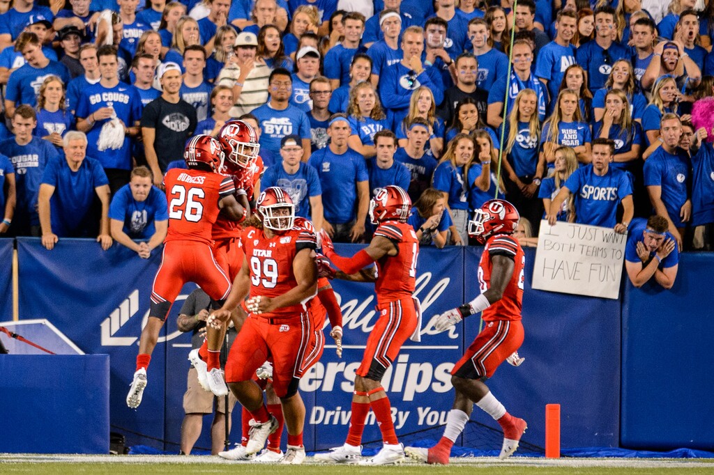 (Trent Nelson | The Salt Lake Tribune)
Utah Utes linebacker Francis Bernard (13) scores on an interception, as BYU hosts the University of Utah on Aug. 29, 2019. The Utes and Cougars have seven games scheduled against each other through 2030, though shifts in the college football landscape could impact future scheduling.
