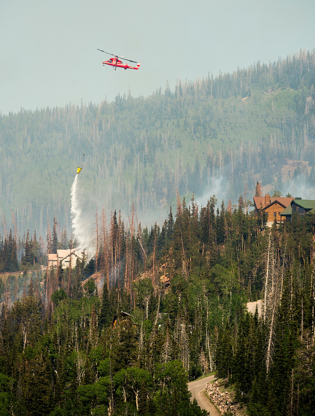 (Leah Hogsten  |  The Salt Lake Tribune) In this June 2017 file photo, firefighting crews and air tankers work to put out a wildfire along the Steam Engine area within Brian Head. The fire forced hundreds to evacuate from the southern Utah ski town.