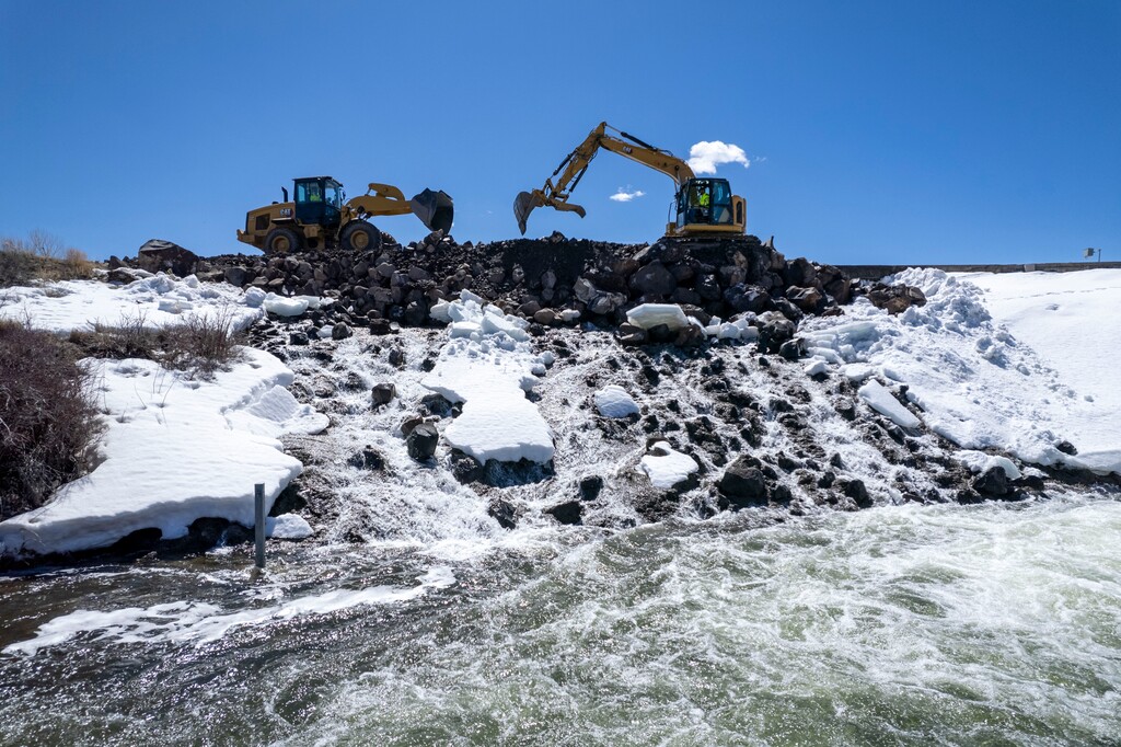 (Rick Egan | The Salt Lake Tribune)  Workers move earth to secure the rim of the Panguitch Lake Dam, on Thursday, April 11, 2024.