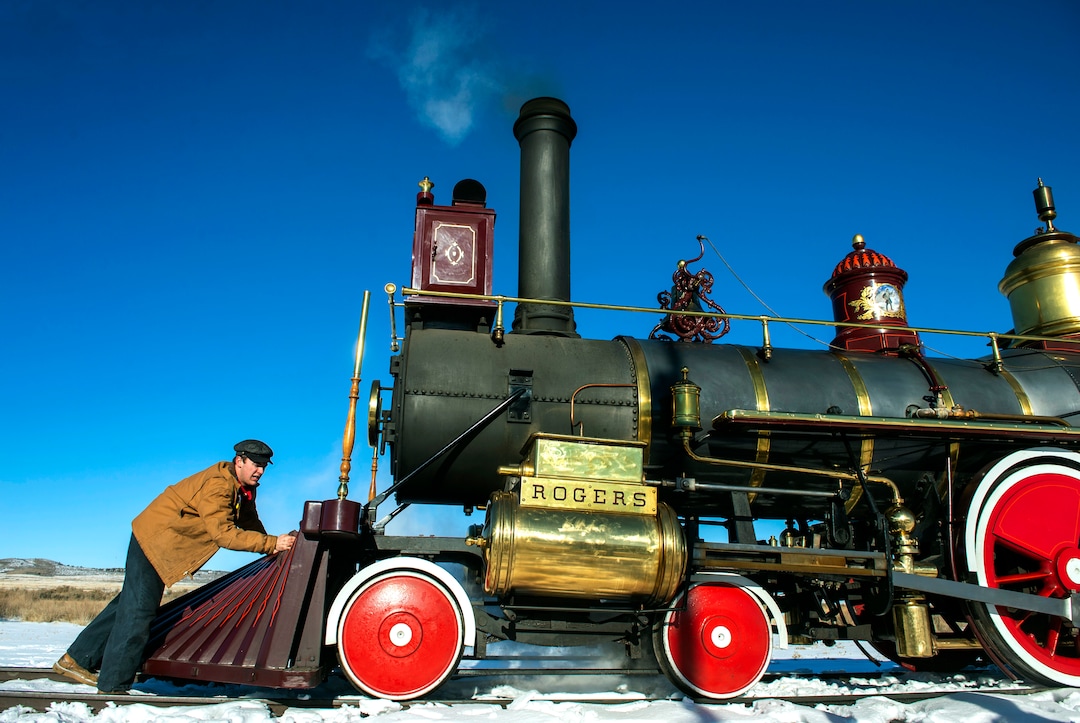 (Rick Egan | The Salt Lake Tribune) Volunteer fireman, Jace Evans, polishes the 119 Steam Engine between runs, at the Golden Spike National Historical Park, on Tuesday, Dec. 29, 2020.