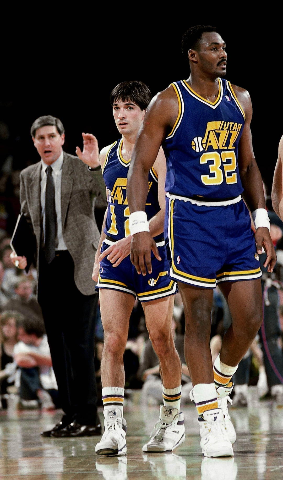 (Photo courtesy Utah Jazz/NBAE) Karl Malone and John Stockton of the Utah Jazz head onto the court after meeting with head coach Jerry Sloan during a game against the Atlanta Hawks in 1986.
