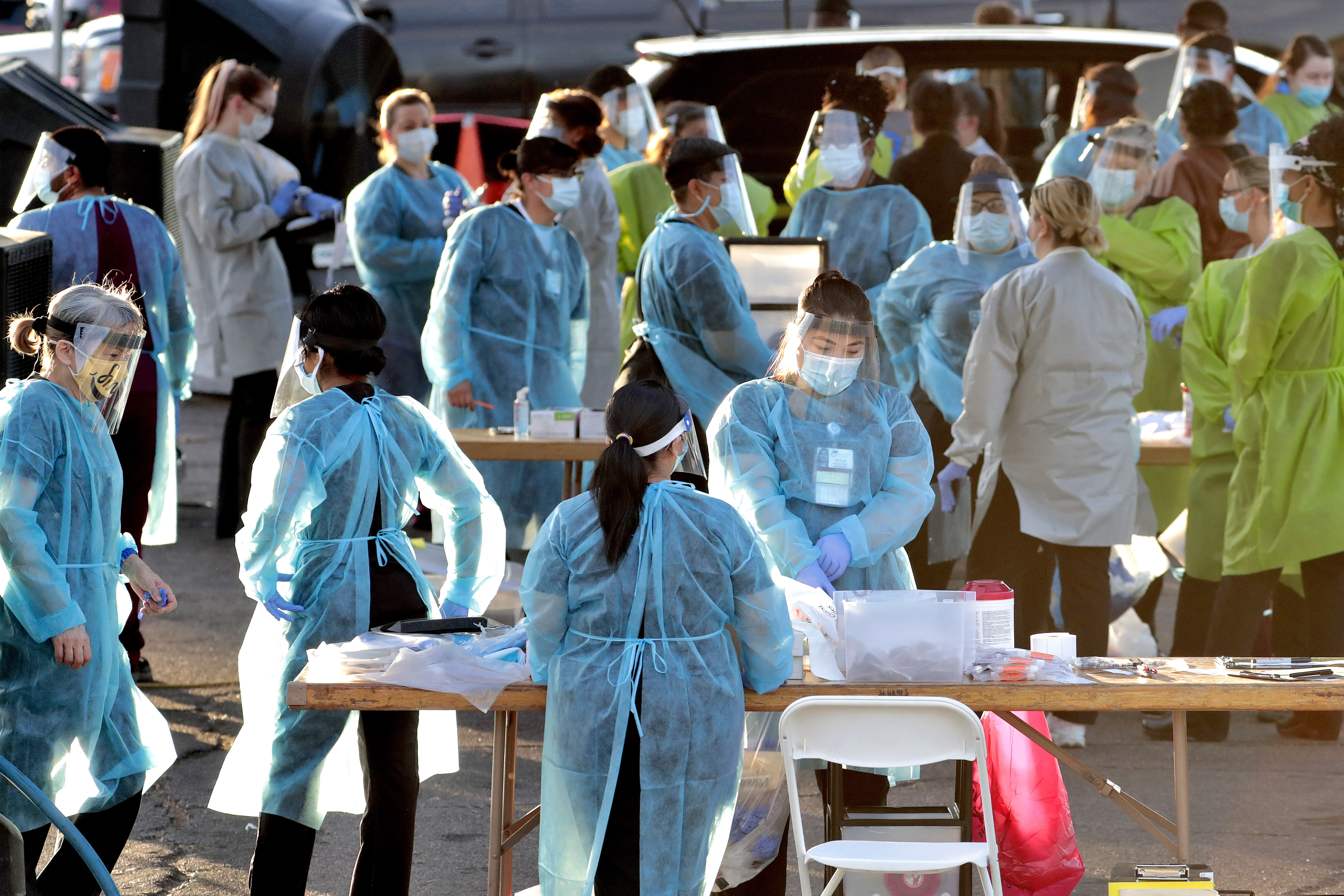 (Matt York | AP) Medical personnel prepare to test hundreds of people lined up in vehicles Saturday, June 27, 2020, in Phoenix's western neighborhood of Maryvalefor free COVID-19 tests organized by Equality Health Foundation, which focuses on care in underserved communities. As coronavirus infections explode in states like Arizona and Florida, people in communities of color are fighting to get tested. Public health experts say wider testing helps people in underserved neighborhoods and is key to controlling a pandemic.