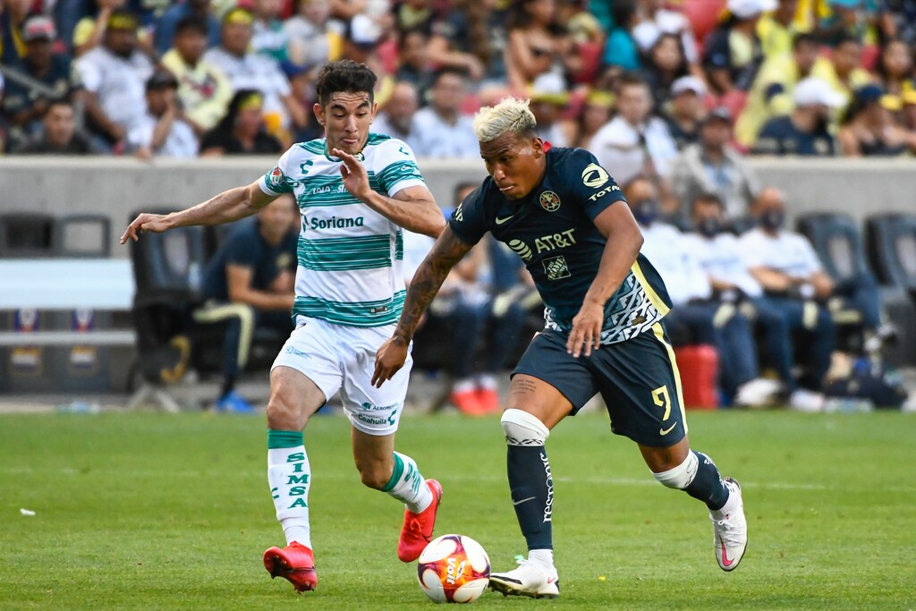 (Alex Goodlett | AP) Santos Laguna forward Jesús Ocejo, right, defends Club América forward Roger Martínez, left, during a Liga MX friendly soccer match Sunday, July 4, 2021, in Sandy.