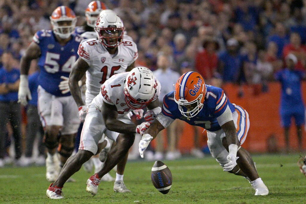 (Phelan M. Ebenhack | AP) Florida running back Trevor Etienne (7) recovers his own fumble in front of Utah cornerback Clark Phillips III (1) during the second half of an NCAA college football game, Saturday, Sept. 3, 2022, in Gainesville, Fla.
