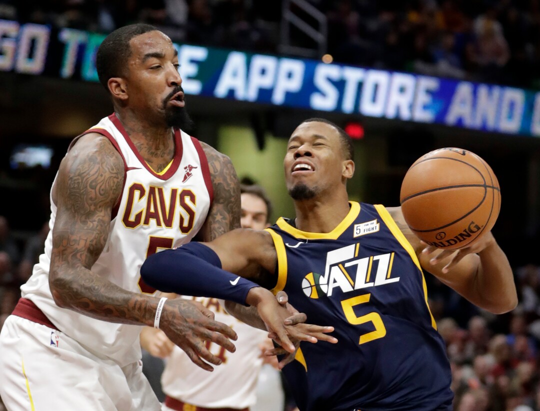 Cleveland Cavaliers' JR Smith, left, knocks the ball loose from Utah Jazz's Rodney Hood in the first half of an NBA basketball game, Saturday, Dec. 16, 2017, in Cleveland. (AP Photo/Tony Dejak)