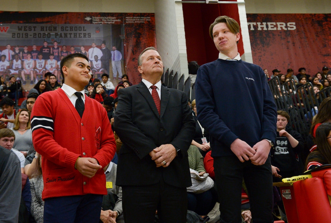 (Leah Hogsten  |  The Salt Lake Tribune) l-r West High School students, Felix Ortiz and Grant Dunkley smile at each other as they are recognized for saving the life of Assistant Attorney General David Carlson, center, during an assembly at the school, Jan. 17, 2020. On February 19, 2019, Ortiz and Dunkley both pulled over to assist Carlson out of  his overturned car on the 600 North bridge in Salt Lake City where Ortiz performed life-saving CPR until first responders arrived on the scene.