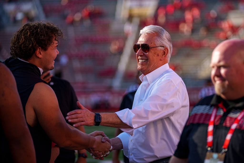 (Trent Nelson | The Salt Lake Tribune) Apostle Dieter F. Uchtdorf visits with players at a Utah football game in 2024.