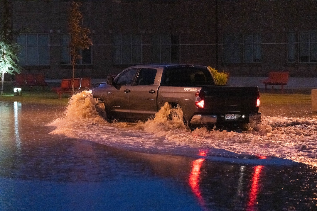 (Francisco Kjolseth | The Salt Lake Tribune) A truck drives though the severely flooded East High roundabout, following a torrential downpour on Sunday, Aug. 1, 2021.
