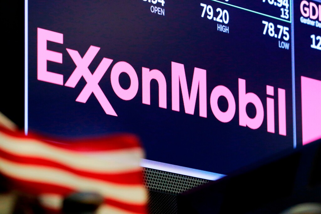 FILE - In this April 23, 2018, file photo, the logo for ExxonMobil appears above a trading post on the floor of the New York Stock Exchange. New York’s attorney general is accusing Exxon Mobil of lying to investors about how profitable the company will remain as governments impose stricter regulations to combat global warming. The lawsuit is set to go to trial Tuesday, Oct. 22, 2019. (AP Photo/Richard Drew, File)