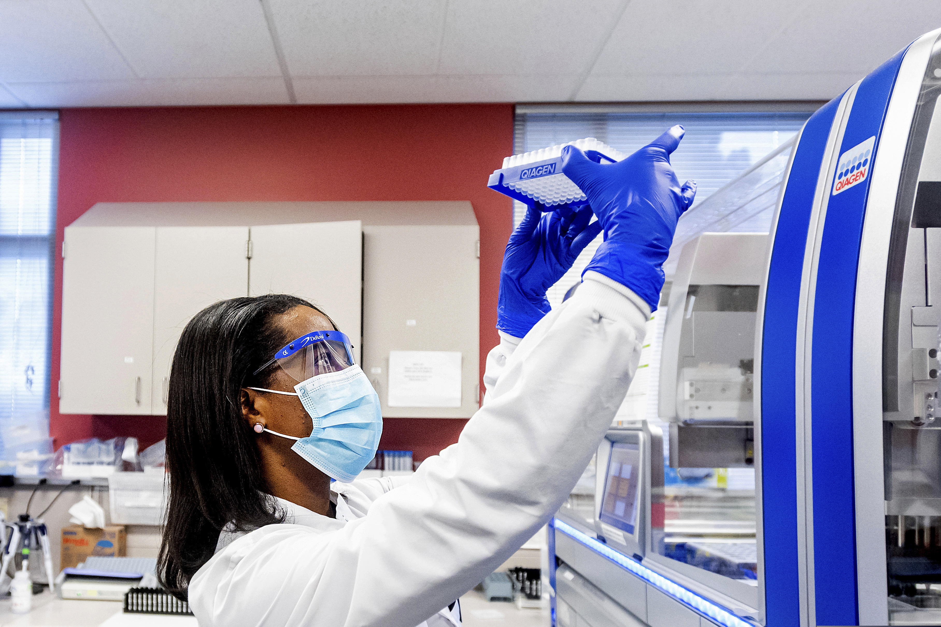 (Noah Berger | AP) A clinical lab scientist processes upper respiratory samples from patients suspected of having COVID-19 at the Stanford Clinical Virology Laboratory in 2021.