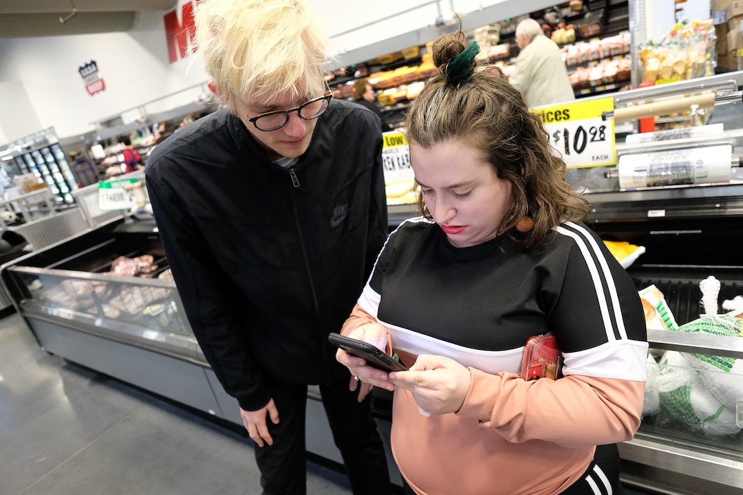 (Francisco Kjolseth  |  The Salt Lake Tribune) Shandra Benito and Taylor Almond check their list as they shop for a family at WinCo Foods in Salt Lake City on Wednesday, March 18, 2020, as part of a newly formed Salt Lake Valley COVID Mutual Aid group that connects volunteers with people who need help during the coronavirus outbreak.