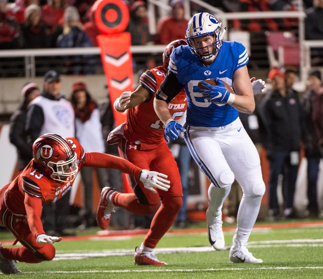 (Rick Egan  |  The Salt Lake Tribune)      Brigham Young Cougars tight end Matt Bushman (89) gets past Utah defensive back Marquise Blair (13) and Utes defensive back Corrion Ballard (15) to score a touchdown for the Cougars, in football action between the Brigham Young Cougars and the Utah Utes, at Rice-Eccles Stadium, Saturday, November 24, 2018.