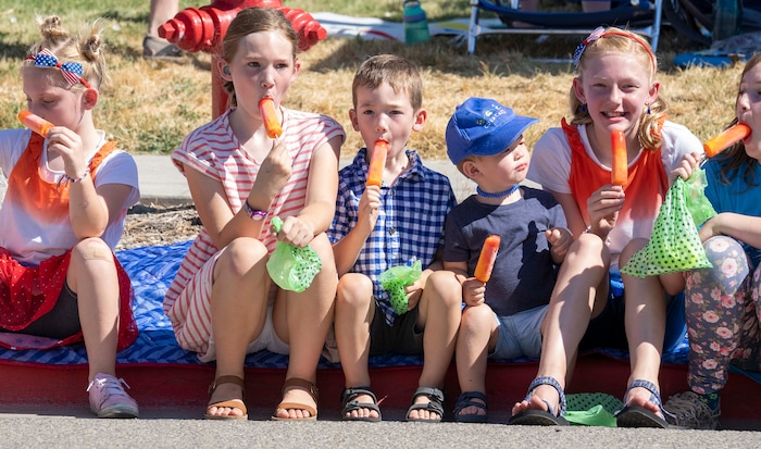(Rick Egan | The Salt Lake Tribune)  Kids eat the free popsicles before the parade, at the Layton Liberty Days, on Monday, July 5, 2021.